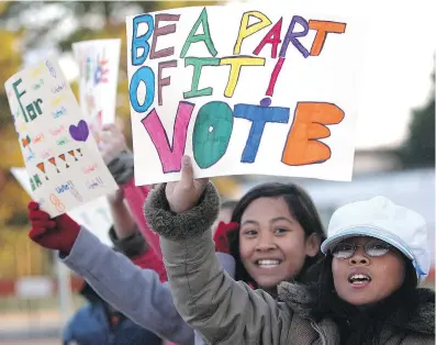  ??  ?? Grade 6 students from Annunciati­on Elementary School in Edmonton encouraged passing motorists to vote in the last federal election. Letter writer Matt Grant suggests that with many young people engaged with today’s issues, the voting age should be...