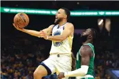  ?? JED JACOBSOHN/ASSOCIATED PRESS ?? Golden State’s Steph Curry, left, drives past Boston’s Jaylen Brown during Game 1 of the Finals on Thursday in San Francisco. Curry had a game-high 34 points.