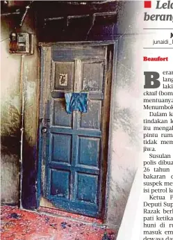  ??  ?? KEADAAN pintu kesan kebakaran selepas dibaling botol berisi petrol di Kampung Melikai, Menumbok.