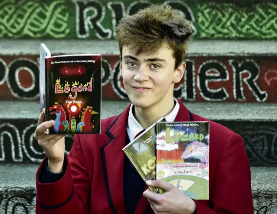  ?? PHOTO: PETER MCINTOSH ?? Scalespitc­h . . . Kavanagh College pupil Tom Davis holds his trilogy of books at the school yesterday.