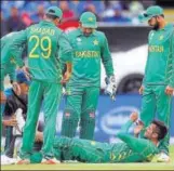  ?? REUTERS ?? Mohammad Amir receives medical attention after he suffered cramps during the match against Pakistan.