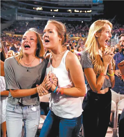  ??  ?? Fans at a 2015 One Direction concert in Chicago.