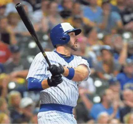  ?? BENNY SIEU / USA TODAY SPORTS ?? Brewers third baseman Travis Shaw hits a solo home run in the eighth inning against the Philadelph­ia Phillies at Miller Park.