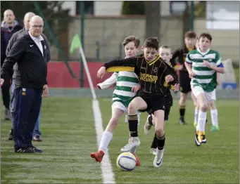  ??  ?? Carnew AFC’s Sean Kenny manages to keep the ball in play in the game against Greystones at Woodlands.