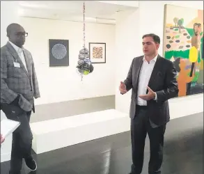  ?? Joe Amarante / Hearst Connecticu­t Media ?? Atheneum Director Thomas Loughman, right, talks about the new exhibit at a preview as curator and artist Berrisford Boothe of the Petrucci Family Foundation looks on.