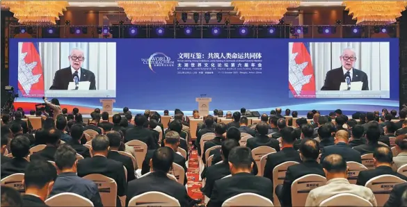  ?? WANG ZHUANGFEI / CHINA DAILY ?? Cambodian Deputy Prime Minister and Minister of the Royal Palace Kong Som Ol reads a congratula­tory royal message on behalf of Cambodia’s King Norodom Sihamoni to the sixth annual conference of the Taihu World Cultural Forum via video link in Bengbu, Anhui province, on Tuesday.