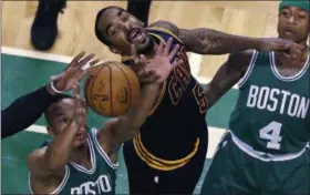  ?? CHARLES KRUPA — THE ASSOCIATED PRESS ?? Cavaliers guard J.R. Smith (5) battles for a rebound against Celtics guard Avery Bradley, left, during the first quarter Boston on April 5, 2017. At right is Celtics guard Isaiah Thomas.