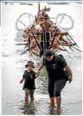  ?? TE RAWHITIROA BOSCH ?? A photograph from the exhibition He Kaupapa Waka shows a woman and child in front of a waka taua at Waitangi in 2020.