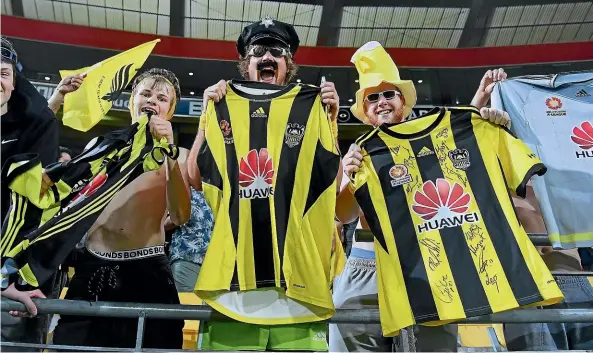  ?? PHOTOSPORT ?? Phoenix fans celebrate a win over Central Coast Mariners at Westpac Stadium in January.