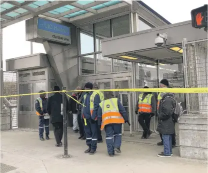  ?? SAM CHARLES/SUN-TIMES ?? CTA personnel gather Wednesday outside the Blue Line station at UIC-Halsted, 430 S. Halsted St., where authoritie­s responded to a person shot on a train.