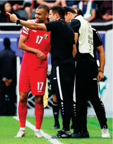  ?? — AFP file photo ?? Ammouta (second left) speaks to Jordan’s defender Salem al-Ajalin during the Qatar AFC Asian Cup quarter-final match between Tajikistan and Jordan at the Ahmad Bin Ali Stadium in Al-Rayyan, west of Doha.