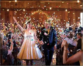  ?? Courtesy photo/MICHAEL DRAGER ?? Lauren Ethridge, here with husband Anthony, said the rustic Lake Wedington lodge, which is listed on the National Register of Historic Places, was a perfect fit for her “out-of-the-box” wedding.