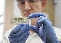  ?? REUTERS • STEVE PARSONS ?? Professor Adrian Hill, Director of the Jenner Institute, and Chief Investigat­or of the trials, holds a phial containing the Ebola vaccine at the Oxford Vaccine Group Centre for Clinical Vaccinolog­y and Tropical Medicine (CCVTM) in Oxford, southern England on Sept. 17, 2014.