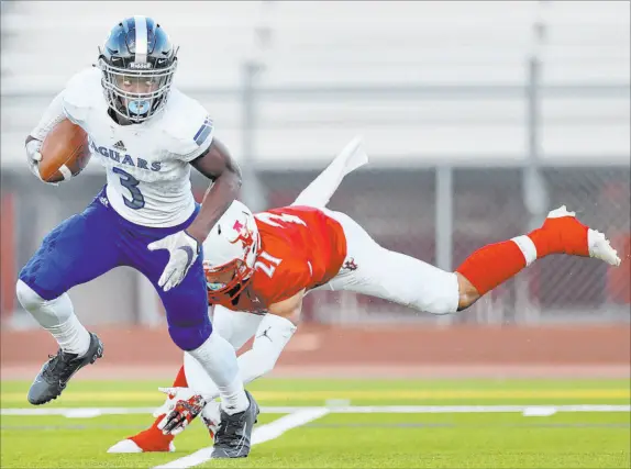  ?? Erik Verduzco Las Vegas Review-journal @Erik_verduzco ?? Desert Pines’ Lavon Brown escapes a tackle by Arbor View’s Aiden Powell on a punt return, but the Jaguars lost 22-21 to the Aggies on Friday.