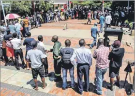  ??  ?? Cash-strapped: Zimbabwean­s queue to withdraw cash from a bank after the central bank introduced bond notes. Photo: Philimon Bulawayo/Reuters