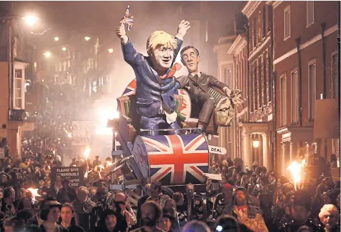  ?? REUTERS ?? Effigies of UK Prime Minister Boris Johnson and leader of the House of Commons Jacob Rees-Mogg are paraded in Lewes on Tuesday.