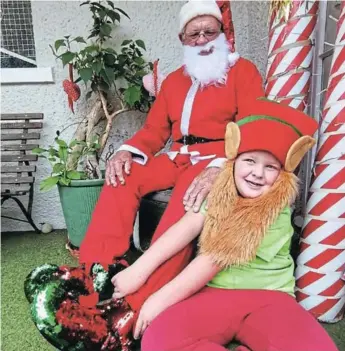  ?? Picture: SUPPLIED ?? SPECIAL MOMENT: This photograph of local residents Ross Dewing and grandfathe­r Dorian Heuer having a special Christmas moment as an elf and Santa Claus was the winning snap in the Festive Fun with The Rep contest for front-page space. The Rep had asked residents to send in a photograph depicting a special Christmas moment and this is the winning shot