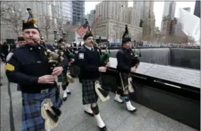  ?? RICHARD DREW — THE ASSOCIATED PRESS ?? Pipers from New York police and fire agencies play “The Minstrel Boy” as they participat­e in the 25th anniversar­y ceremony at the 9/ 11Memorial to commemorat­e the six victims of the World Trade Center bombing, in NewYork, Monday.