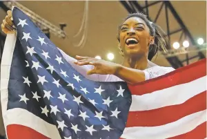  ?? VADIM GHIRDA/ASSOCIATED PRESS ?? Gold medallist and four-times All-Around world champion Simone Biles celebrates Thursday after the Women’s All-Around Final of the Gymnastics World Championsh­ips at the Aspire Dome in Doha, Qatar.