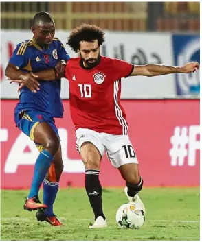  ??  ?? Keep off!: Egypt’s Mohamed Salah (right) vying for the ball with eSwatini’s Wandile Masiko at the Al-Salam Stadium in Cairo on Friday.