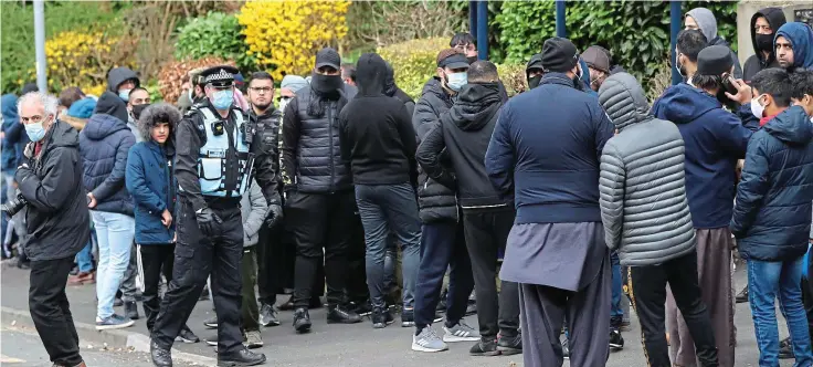  ??  ?? Outcry: Protesters gather outside Batley Grammar School, West Yorkshire, for a second day yesterday after pupils were shown cartoons in class discussion on blasphemy