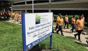  ?? Photos by Arnold Gold/Hearst Connecticu­t Media ?? Employees of Avangrid subsidiary United Illuminati­ng last summer outside the New Britain office of the Connecticu­t Public Utilities Regulatory Authority. The Orange-based utility is now asking regulators for a $14 million interim rate increased after PURA commission­ers dramatical­ly cut a $130 million rate increase that UI had sought earlier this year.