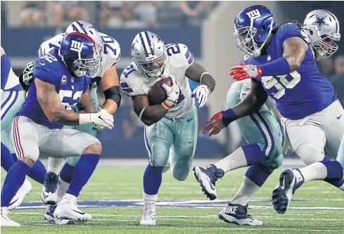  ?? AP ?? Cowboys running back Ezekiel Elliott, No.21, is defended by the Giants’ Jonathan Casillas, left, and Damon Harrison.