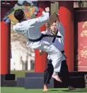  ??  ?? Elicio Peña (left) and Timothy Yi take part in the NB Taekwondo demo performanc­e at the Chinese Week Culture and Cuisine Festival.