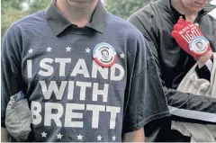  ??  ?? HE’S WITH US: Men declare their support for Judge Brett Kavanaugh on the day he and Christine Blasey Ford testified before senators, in Washington last month.