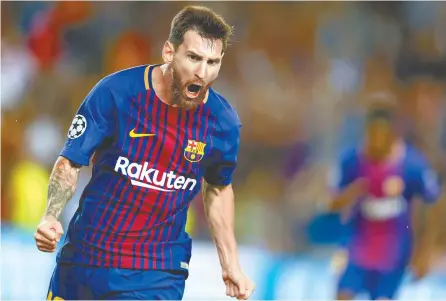  ?? AP-Yonhap ?? Barcelona's Lionel Messi celebrates scoring his side's first goal during a Champions League group D football match between FC Barcelona and Juventus at the Camp Nou stadium in Barcelona, Spain, Tuesday.