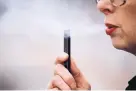  ?? CRAIG MITCHELLDY­ER/ASSOCIATED PRESS ?? A woman exhales a puff of vapor from a Juul pen in Vancouver, Washington. A former executive alleges that the company knowingly shipped tainted nicotine pods.