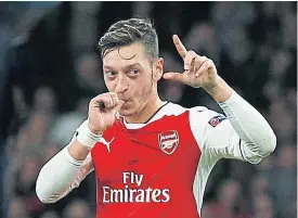  ??  ?? Arsenal’s Mesut Oezil celebrates his hat-trick against Ludogorets.