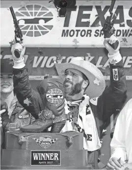  ?? AP ?? Jimmie Johnson fires commemorat­ive pistols in victory lane after winning the NASCAR Cup Series race Sunday at Texas Motor Speedway.