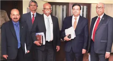  ?? PHOTO: PTI ?? RBI Governor Urjit Patel ( second from right) with Deputy Governor ( from left) N S Vishwanath­an, Executive Director Michael Patra, deputy governors R Gandhi and S S Mundra at a press conference in Mumbai after the monetary policy review meeting on...