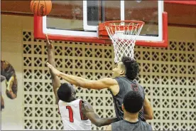  ?? MARC PENDLETON / STAFF ?? Trotwood’s Amari Davis (1) gets a shot off over Wayne’s L’Christian “Blue” Smith. Wayne defeated host Trotwood-Madison 90-87 in double-OT Friday.