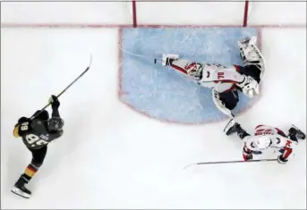  ?? JOHN LOCHER — THE ASSOCIATED PRESS ?? Washington goaltender Braden Holtby, center, makes a stick save on a shot by Vegas’ Alex Tuch, left, as John Carlson watches during the third period in Game 2of the Stanley Cup Final on Wednesday in Las Vegas.