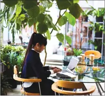  ??  ?? This undated photo provided by Paul Barbera shows artist Takahashi Kiroko on the second floor of her studio working while surrounded by plants in Tokyo.