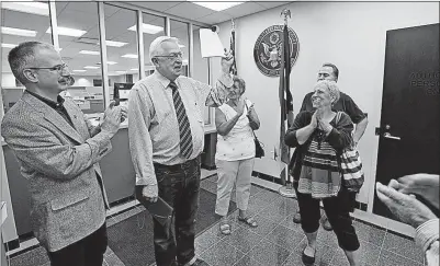  ?? [ERIC ALBRECHT/DISPATCH PHOTOS] ?? Larry Koebel Sr. shows other parents of disabled children a copy of some of the motions filed in federal court on Thursday to keep their children from being part of a class-action lawsuit. The parents say they’d prefer to be individual­ly represente­d...