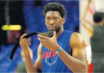  ?? CHRIS SZAGOLA/AP ?? Philadelph­ia’s Joel Embiid will miss tonight’s Game 2 against the Heat. He has cleared concussion protocol but is still recovering from the fractured orbital bone.