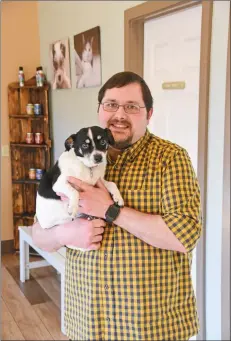  ?? STACI VANDAGRIFF/THREE RIVERS EDITION ?? Dr. Ryan Sartin holds his dog, Cricket, inside his clinic at Heber Springs. Sartin was recently named the Heber Springs Area Chamber of Commerce board president for 2020.