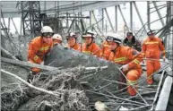  ?? WAN XIANG / XINHUA ?? Rescuers search for trapped workers after the deadly collapse of a constructi­on platform at a cooling tower at Fengcheng Power Plant in Yichun, Jiangxi province, on Thursday morning.