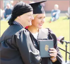  ?? Westside Eagle Observer/RANDY MOLL ?? Kaitlyn Loyd poses for a photo with class sponsor and teacher Carla Hicks after receiving her diploma at Gravette graduation ceremonies on Saturday, April 12, 2018. RANDY MOLL rmoll@nwadg.com