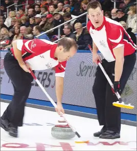  ?? CP PHOTO ?? Ben Hebert, right, and Brent Laing sweep a stone during action at the Tim Hortons Brier.