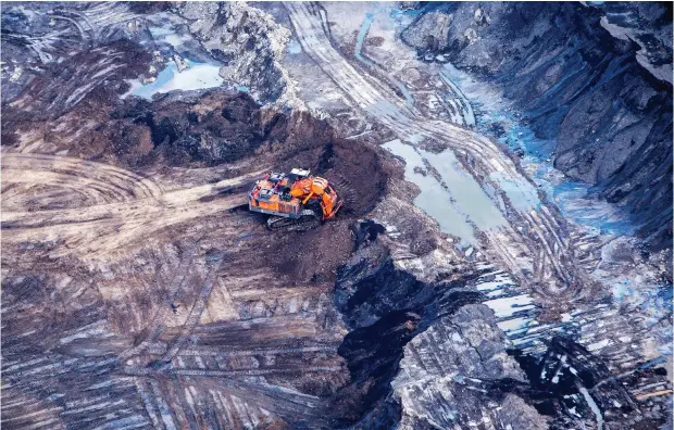  ?? BEN NELMS / BLOOMBERG FILES ?? An excavator is seen at the Suncor Energy Inc. Millennium mine near Fort Mcmurray, Alta. Suncor has performed well relative to its global peers.