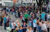  ?? — AFP ?? People queue at polling stations at Carabobo Square in Caracas during an opposition-organised vote to measure public support for President Nicolas Maduro’s plan to rewrite the Constituti­on on Sunday.