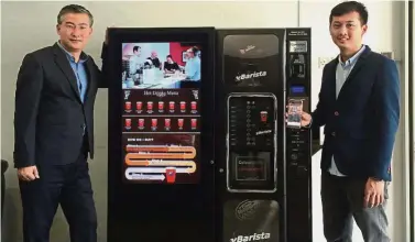  ??  ?? New coffee maker: Woo (left) and Koh hope to deploy their vending machines to 1,000 locations in two years.