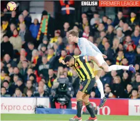  ?? AP ?? John Stones (right) of Manchester City beats the challenge of Watford’s Troy Deeney to head the ball during their English Premier League match at Vicarage Road stadium in Watford on Tuesday. City won 2-1. —