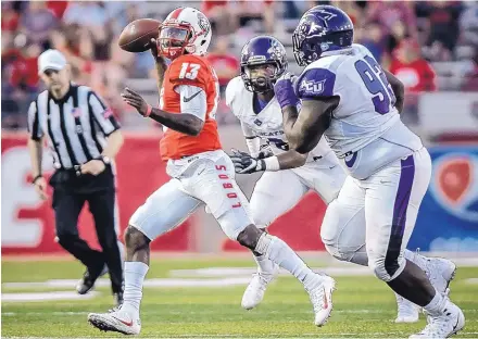  ?? ROBERTO E. ROSALES/JOURNAL ?? UNM quarterbac­k Lamar Jordan (13) avoids Abilene Christian’s Dante Hibert as he prepares to pass during Saturday’s season opener. Jordan says the Lobos need to treat Saturday’s rivalry game with New Mexico State as they would any other game.