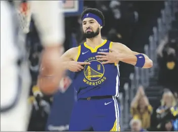  ?? TONY AVELAR/AP ?? GOLDEN STATE WARRIORS GUARD KLAY THOMPSON (11) reacts after making a 3-point shot against the Memphis Grizzlies during the first half of Game 6 of a Western Conference playoff semifinal in San Francisco on Friday.