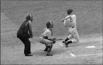  ?? THE ASSOCIATED PRESS ?? Joe DiMaggio of the New York Yankees singles to center in the first inning of the second game of a doublehead­er against the Boston Red Sox at Yankee Stadium on July 2, 1941. The hit ran his streak to 44 games, equaling the record set in 1897 by Willie...